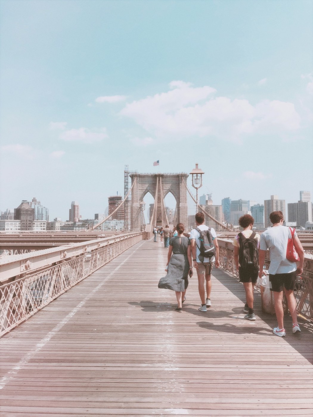 Friends walking across the Brooklyn Bridge